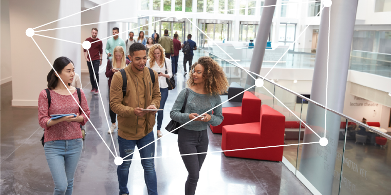 students walking through a campus space 