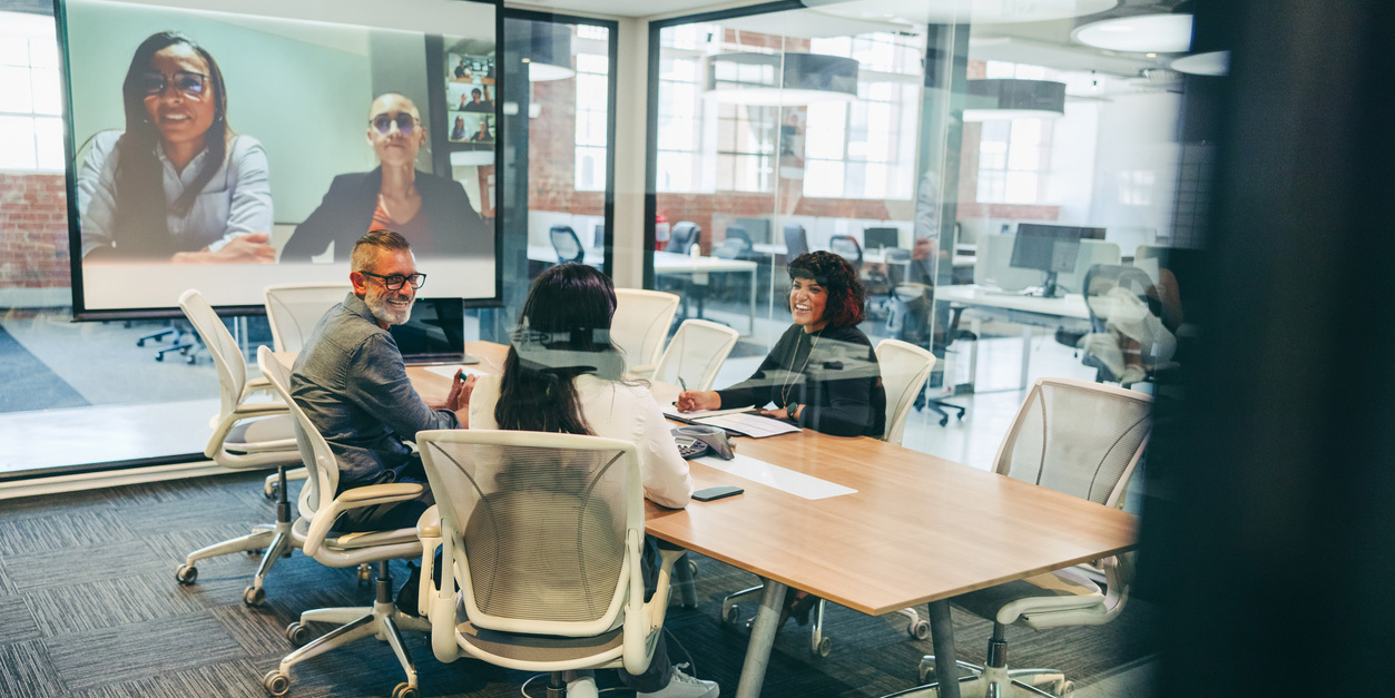 workers gathered around a table discussing meaningful work