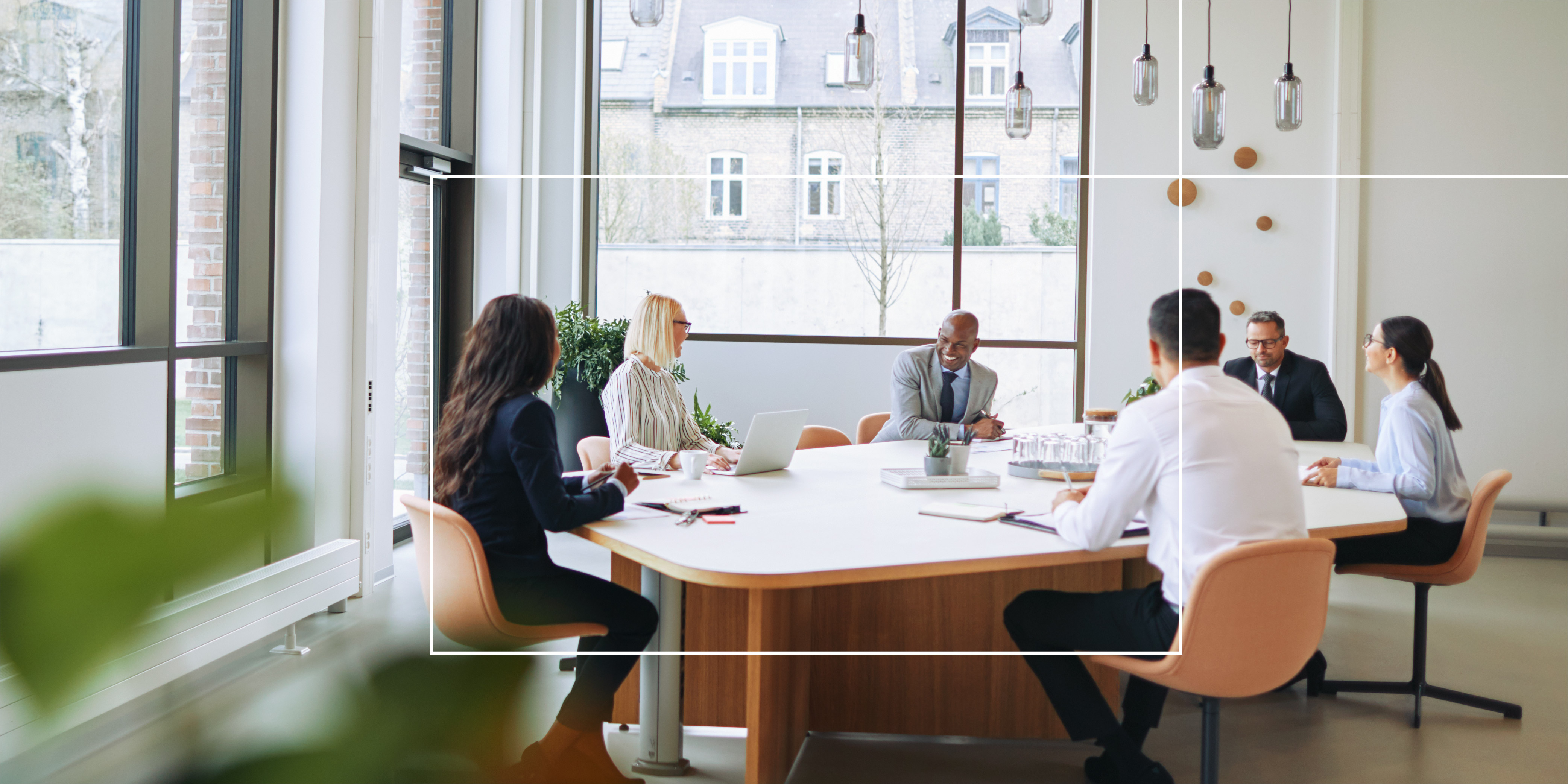 coworkers in a meeting in a hybrid workspace
